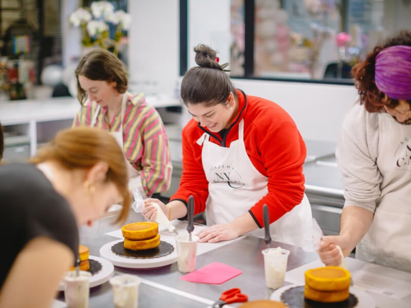 A group of students working together at a baking class